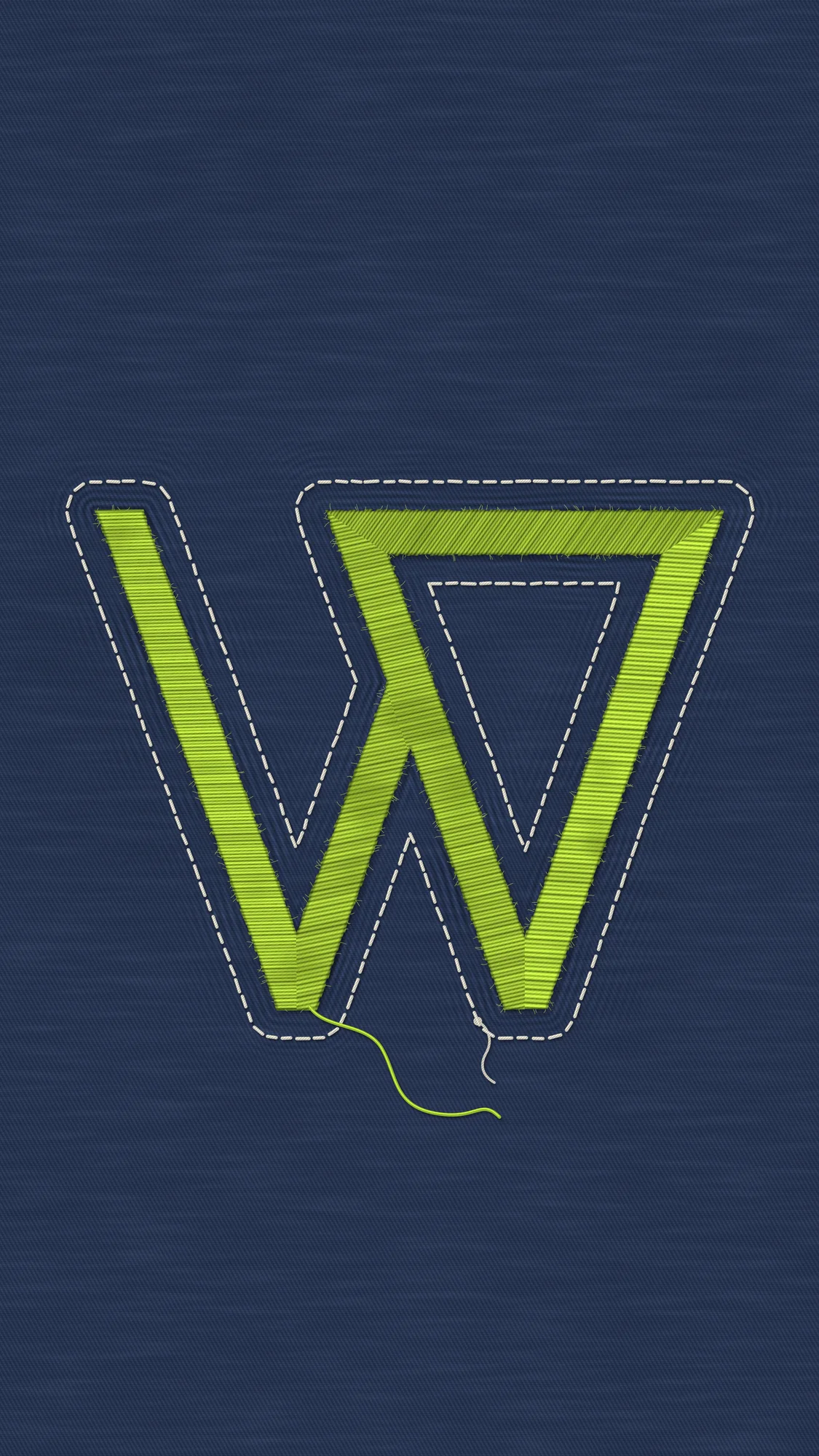 Embroidered W: A lime satin-stitch W on puckered indigo denim, with uneven hand-run off-white stitches, a visible tie-off knot and a loose thread end.