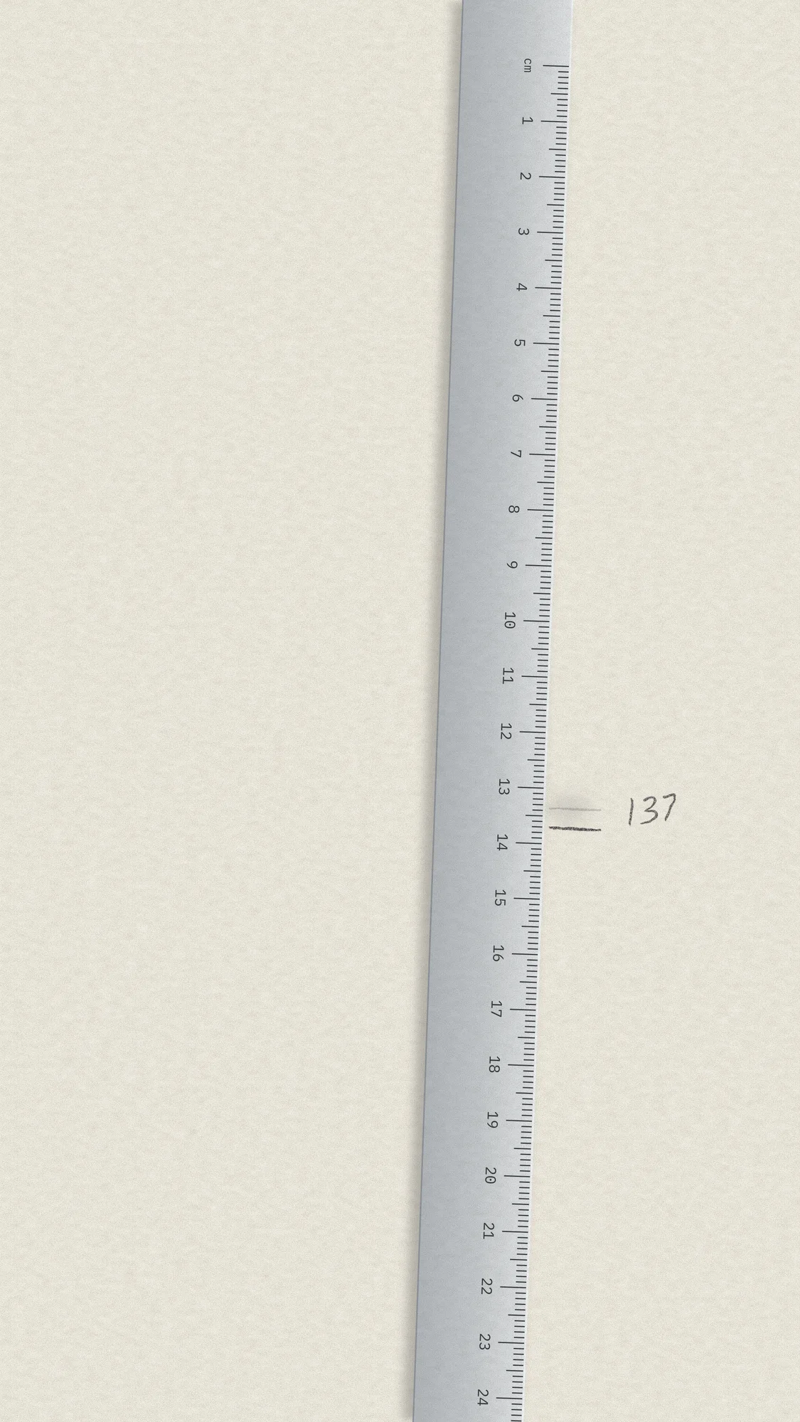 Measure Twice: A steel rule runs down the side of the phone screen, with a confident pencil mark, a ghost of the first attempt rubbed out next to it, and a small pencilled note.