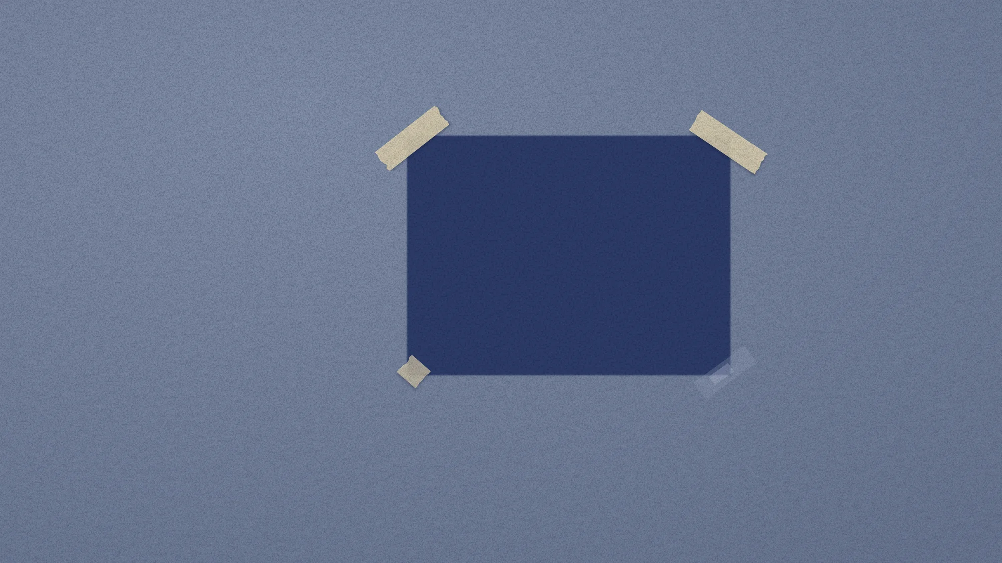 Where the Photo Was: Sun-faded navy sugar paper with one deep, unfaded rectangle where a photo hung for years. Two strips of masking tape still hold its top corners; the bottom ones were torn away.